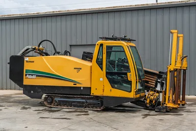 Side view of 2017 Vermeer 40x55 S3 HDD with enclosed cab, steel tracks, and rack of drill pipe in good condition.