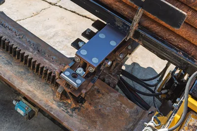 Vermeer D36x50 Series II rack and pinion carriage assembly with drill pipe rack, rollers, and hydraulic components.