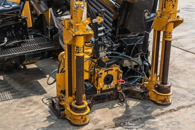 Close-up front view of Vermeer 24x40 Series II HDD drill rig showing hydraulic stabilizers, carriage, and pipe rack assembly.