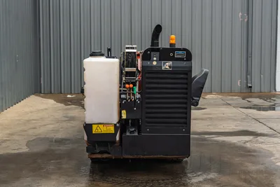 2016 Ditch Witch JT9 HDD drill rear view showing engine radiator, fluid reservoir, hydraulic lines, exhaust stack, and beacon light