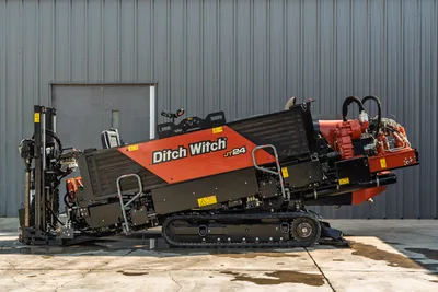 Side view of 2020 Ditch Witch JT24 HDD drill with operator station, tracked undercarriage, and exposed engine compartment.