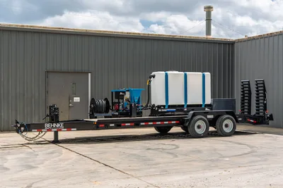 Behnke CBCT2324E-BT-R HDD mud mixing trailer, side view, with SL500 tank, PM170 pump, hose reel, dual axle, and rear ramps