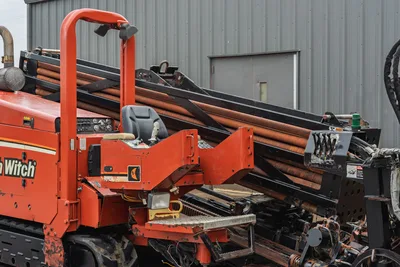 2008 Ditch Witch JT4020 MACH 1 side profile, operator station, drill pipe rack, and tracked undercarriage in used condition.