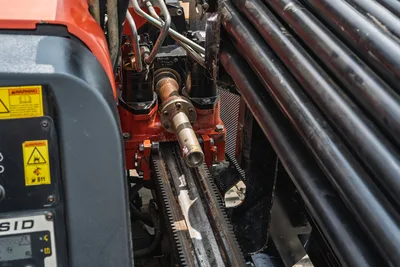 Close-up of 2018 Ditch Witch JT10 drill head, rack and pinion drive system, and drill pipe rack in good visible condition.