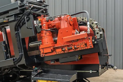Ditch Witch JT3020 carriage assembly showing rotation motor, thrust drive, spindle, and pipe track on main drill frame.