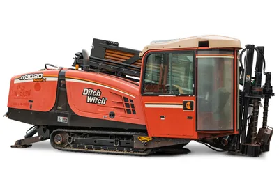 2012 Ditch Witch JT3020 Mach 1 HDD drill, profile view, showing tracks, cab, and drill pipe rack in good condition.