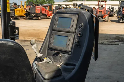 Operator console and dual display screens on 2020 Ditch Witch JT24 directional drill featuring joystick control and armrest.