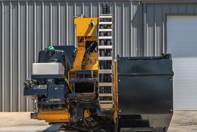 2019 Vermeer D40x55 S3 HDD drill, rear/side view showing carriage, hydraulic hose bundle, drill frame, operator controls, and fluid tank