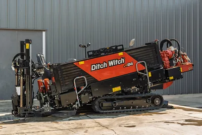 2020 Ditch Witch JT24 directional drill, side profile showing tracks, engine compartment, and carriage with drill pipe rack.