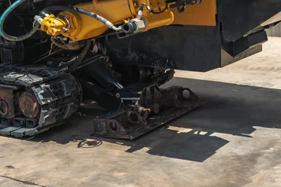 2021 Vermeer D24x40 S3 ground anchor stake and hydraulic cylinder detail, rubber track undercarriage, close-up side view