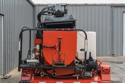 2015 Ditch Witch MR90 mud recycler rear view, orange mixing tank, white water tank, hydraulic manifold, pump assembly, safety frame