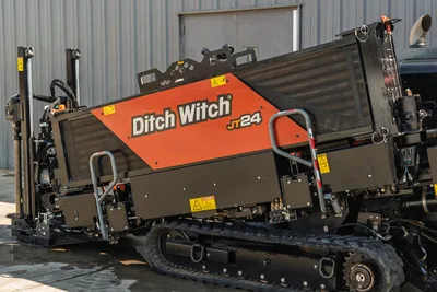 2020 Ditch Witch JT24 directional drill side profile showing engine compartment, cooling system, and rubber track undercarriage.