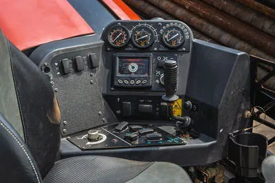 2021 Ditch Witch JT20 operator console showing pullback/torque gauges, digital display, joystick, toggle switches, and drill pipe rack visible behind.