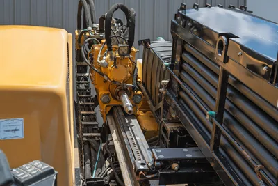 2021 Vermeer D24x40 S3 drill carriage, spindle, rack-and-pinion thrust frame, hydraulic hoses, and stacked drill pipe rack
