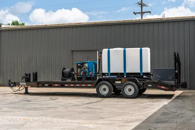 2026 Behnke CBCT2324E-BT-R HDD mud mixing trailer, side view, SL500 mixer, white poly tank, hose reel, tandem axle, black steel frame
