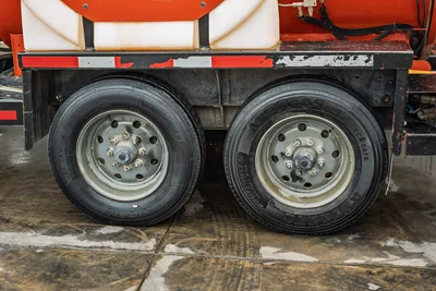 2021 Ditch Witch HX50 mud mixer trailer dual axle tires, steel wheels, orange tank, worn reflective tape on frame