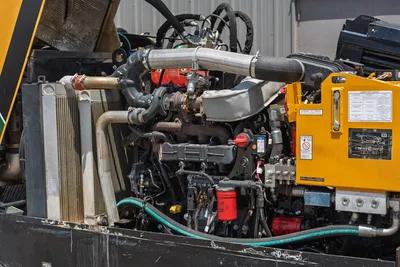 2021 Vermeer D24x40 S3 engine compartment open, showing 125hp diesel engine, turbo, radiator, hydraulic filters, and lubricant chart panel