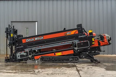 Ditch Witch JT20 horizontal directional drill with 17,000 lbs thrust, tracked undercarriage, drill head assembly, and 74 hp engine, side profile view