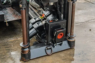 2016 Ditch Witch JT9 drill frame close-up showing carriage assembly, hydraulic components, anchor posts, and sonde housing with red locator port