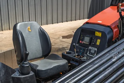 Operator station of 2018 Ditch Witch JT10 HDD drill featuring clean operator seat, controls, ESID display, and drill pipe.