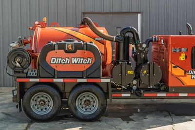 2022 Ditch Witch HX30 mud recycler, side view, 500-gal tank, hose reel, vacuum pump assembly, tandem-axle trailer, orange, good condition