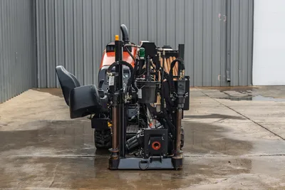 2016 Ditch Witch JT9 HDD drill, rear view showing drill pipe rack, hydraulic lines, anchor system, operator seat, and rotary drive