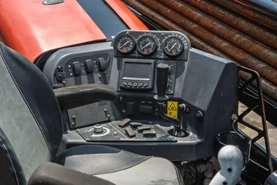 2023 Ditch Witch JT20 operator console with thrust/torque gauges, LCD display, joystick controls, toggle switches, and drill pipe visible background.