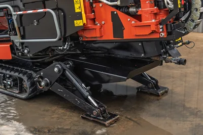 Ditch Witch JT20 HDD drill rig side view showing red rotary head, black drill pipe carrier, tracked undercarriage, 74 hp engine compartment, and hydraulic components
