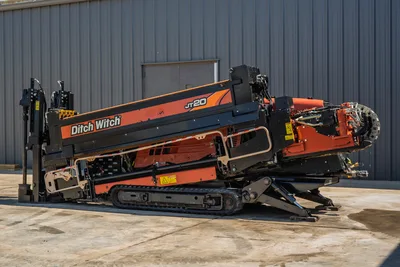 2018 Ditch Witch JT20 horizontal directional drill, side profile view showing tracks, pipe loader, and engine compartment.