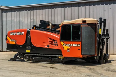 2016 Ditch Witch JT30 All Terrain HDD drill with closed cab, tracks, engine enclosure, and pipe rack in side-profile view.