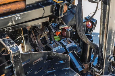 Close-up view of 2021 Ditch Witch JT20 pipe vise breakout system showing hydraulic clamps and steel carriage components.