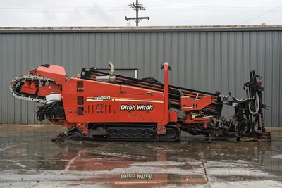 Side profile of 2008 Ditch Witch JT4020 MACH 1 horizontal directional drill showing tracks, pipe rack, and engine cowling.