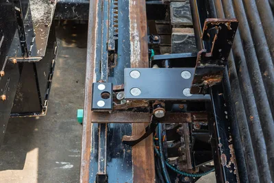 Close-up of Vermeer 24x40 Series II drill rack, carriage, and pipe loading components with visible tracks and gear assembly.
