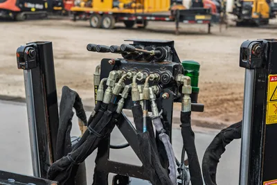 2016 Ditch Witch JT9 hydraulic valve block with multi-lever controls, AN fittings, bundled hoses, and green indicator light