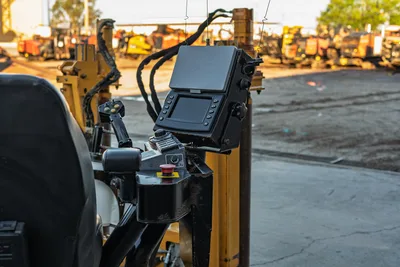 2019 Vermeer D40x55 S3 operator console with LCD display, joystick controls, red e-stop button, and hydraulic hose routing