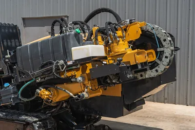 2021 Vermeer D24x40 S3 drill carriage close-up showing spindle, hydraulic hoses, cable track, and fluid reservoirs at elevated angle