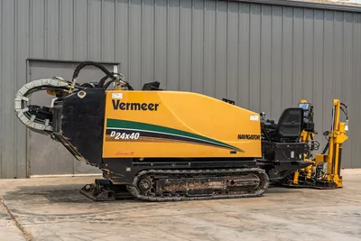 2014 Vermeer D24x40 Series II HDD drill rig, side profile, showing rubber tracks, operator station, and drill pipe rack.