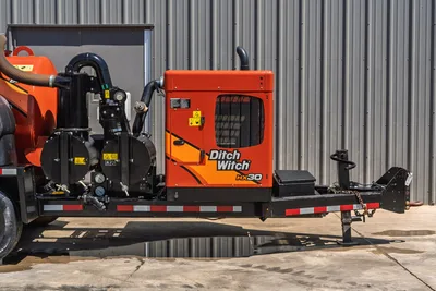 2023 Ditch Witch HX30 mud mixing unit on trailer, side view showing engine enclosure, mud pump, hoses, and pintle hitch
