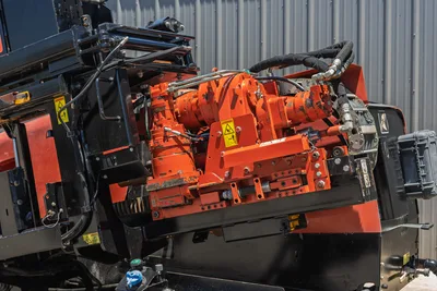 2018 Ditch Witch JT30 All Terrain drill carriage, close-up of orange spindle drive and hydraulic rotary head assembly