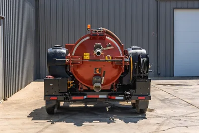 2023 Ditch Witch HX30 mud recycler, rear view showing large red vacuum tank, dual 300L fluid tanks, hose reel, and trailer hitch