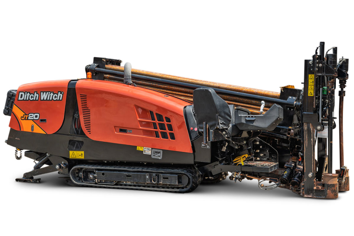2023 Ditch Witch JT20 HDD drill, 3/4 side view, orange cab, rubber tracks, loaded drill pipe rack, rear carriage assembly visible