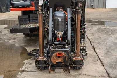 2024 Ditch Witch JT24 front-end close-up showing drill frame, anchor posts, spindle box, hydraulic tank, and wear-worn undercarriage