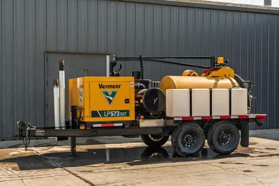 2024 Vermeer LP573SGT vacuum excavator, side view, trailer-mounted, featuring tandem axles, mud tank, and water storage tanks.