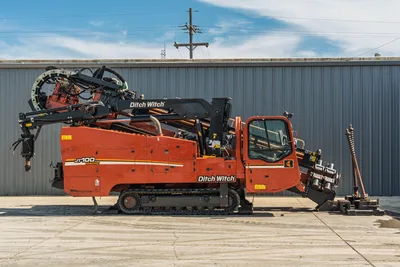 2014 Ditch Witch JT100 Mach 1 HDD drill, full right-side profile, enclosed cab, pipe carousel, thrust frame, rubber tracks, good condition