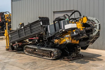 2014 Vermeer 24x40 Series II HDD drill rig, side profile showing pipe rack, hydraulic hoses, tracks, and yellow power unit.