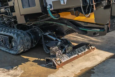2016 Vermeer D23x30 S3 rear undercarriage close-up showing rubber tracks, hydraulic anchor assembly, and ground anchor blade