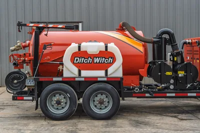 2019 Ditch Witch HX30 vacuum excavator, side profile showing spoils tank, water reservoir, hose reel, and blower assembly.