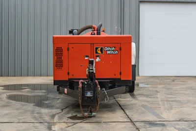 Rear view of 2019 Ditch Witch HX30 vacuum excavator, showing enclosed engine compartment, hitch assembly, and intake hose.