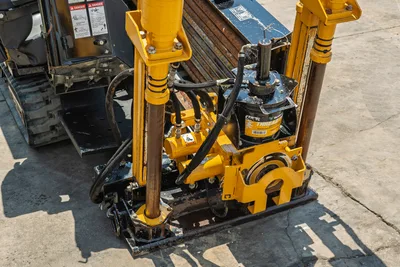 Vermeer 10x15 S3 HDD unit top view showing yellow rotary head, drill pipe, thrust frame, and hydraulic components
