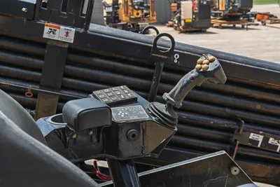 Vermeer D24x40 S3 operator joystick controls with multi-function button panel; stacked HDD drill pipe visible in background